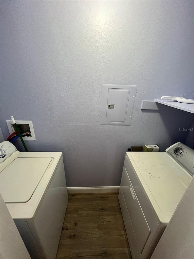 washroom featuring separate washer and dryer, dark wood-type flooring, and electric panel