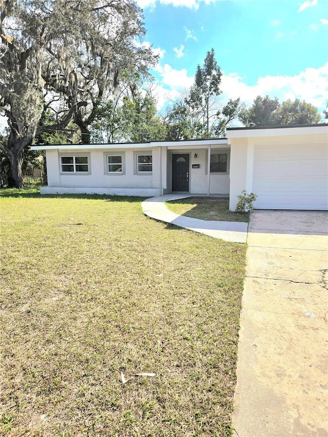 ranch-style home with a front lawn and a garage