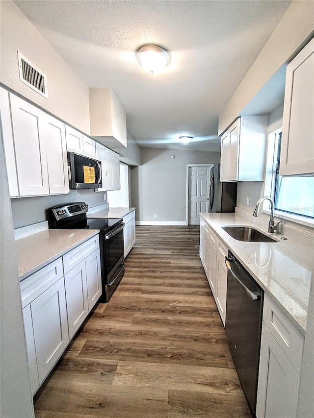 kitchen featuring white cabinets, appliances with stainless steel finishes, and sink