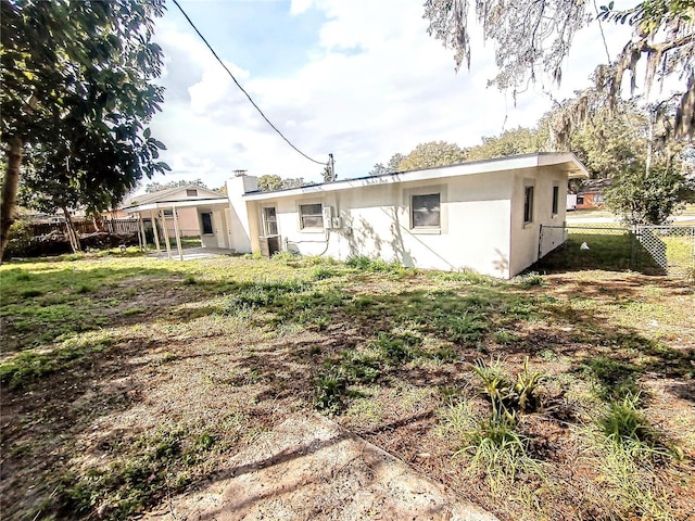 rear view of property with a lawn