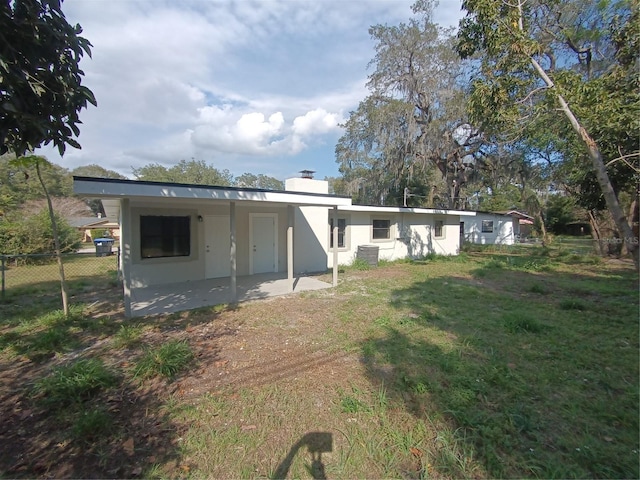 exterior space with a patio area and a lawn