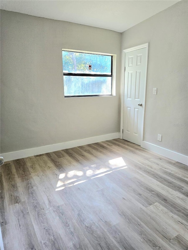 unfurnished room with light hardwood / wood-style floors