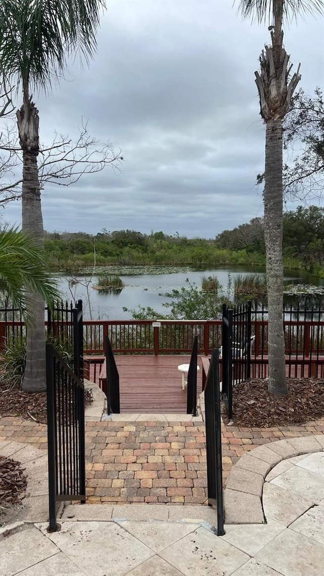 exterior space with a water view and fence