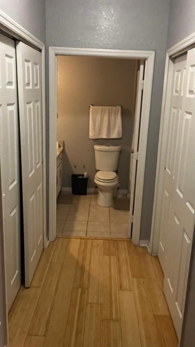 bathroom with wood finished floors and toilet