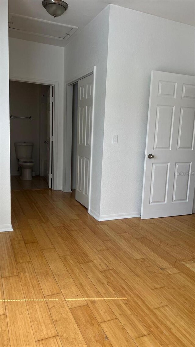 unfurnished room with baseboards and light wood-type flooring