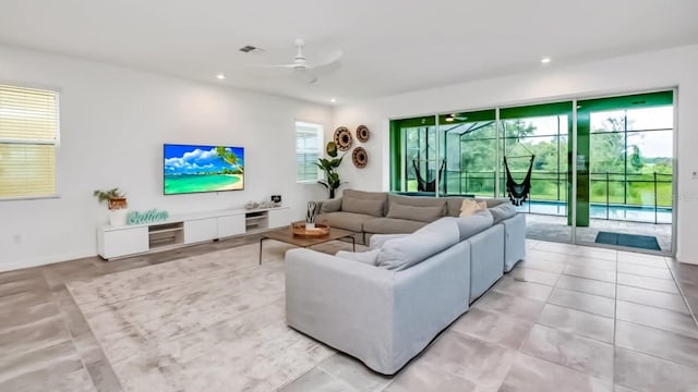 living room with visible vents, light tile patterned flooring, a ceiling fan, and recessed lighting