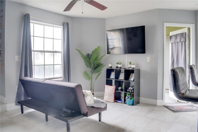 sitting room featuring baseboards and a ceiling fan