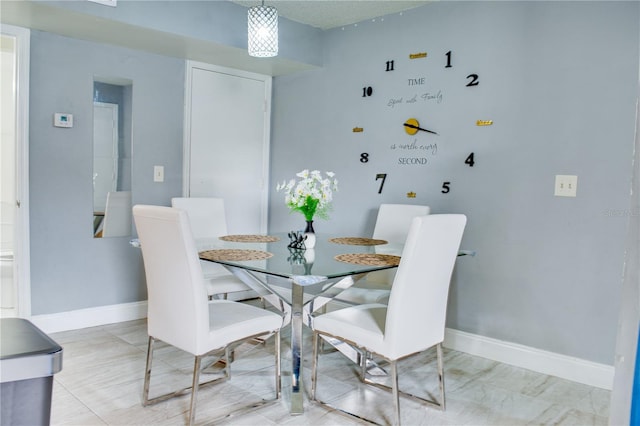 dining space featuring baseboards