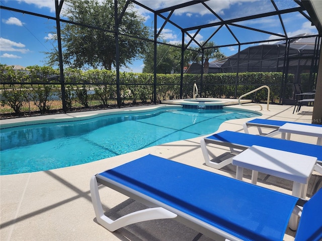 view of pool featuring a patio, glass enclosure, and an in ground hot tub