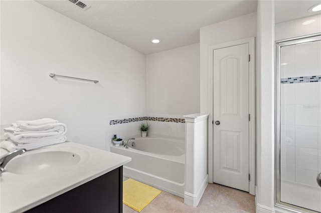 bathroom featuring vanity, tile patterned flooring, and plus walk in shower