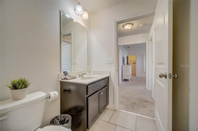 bathroom with vanity, tile patterned floors, and toilet