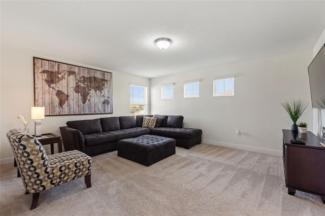 carpeted living room with a textured ceiling and a wealth of natural light