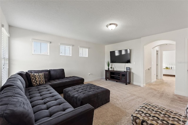 carpeted living room with a textured ceiling