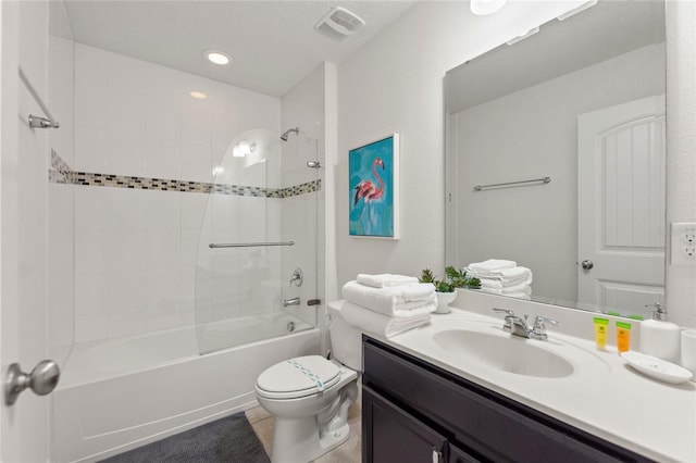 full bathroom featuring tiled shower / bath combo, vanity, tile patterned flooring, and toilet