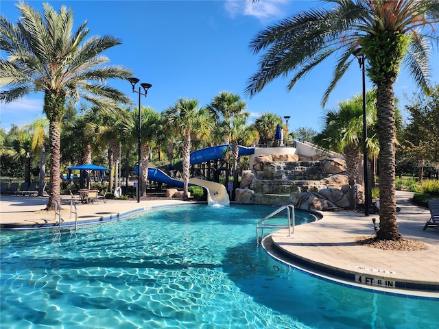 view of swimming pool with a water slide