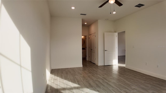 empty room featuring ceiling fan and light hardwood / wood-style flooring