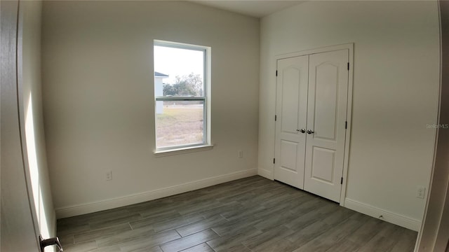 unfurnished bedroom with light wood-type flooring and a closet