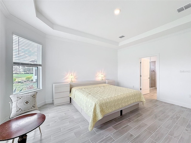 bedroom featuring crown molding and a raised ceiling