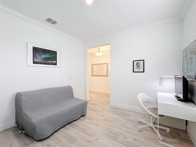 office area with ornamental molding and light hardwood / wood-style flooring