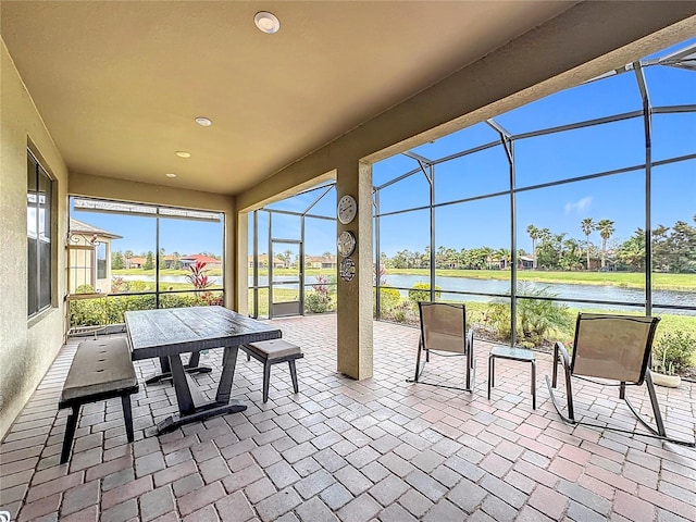 sunroom / solarium with a water view and plenty of natural light