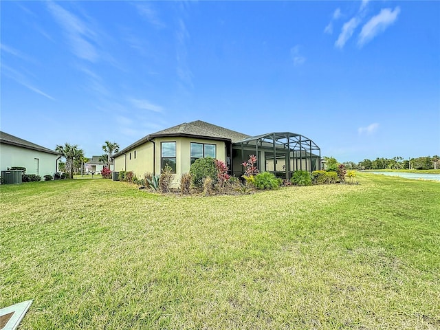 exterior space with central AC, a front lawn, and a lanai