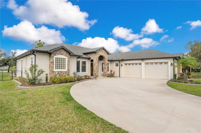 view of front of house with a garage and a front lawn