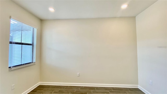 unfurnished room featuring recessed lighting, baseboards, and wood finish floors