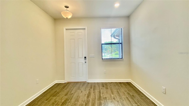 entryway featuring baseboards and wood finished floors