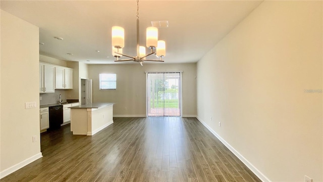 kitchen with black dishwasher, open floor plan, white cabinetry, and a center island