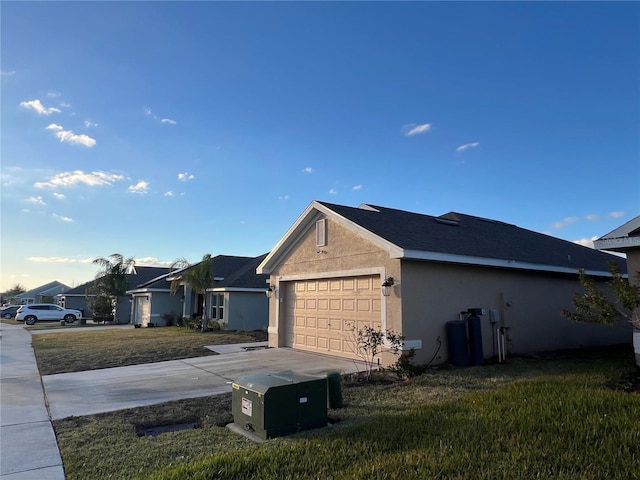 view of home's exterior with a yard and a garage