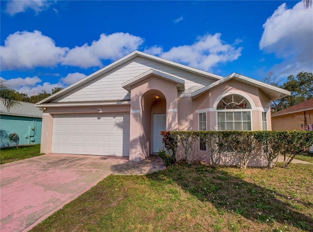 view of front of property with a garage and a front lawn