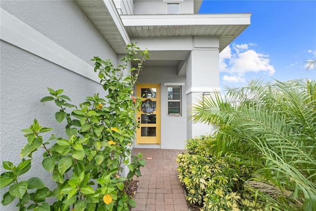 entrance to property featuring stucco siding