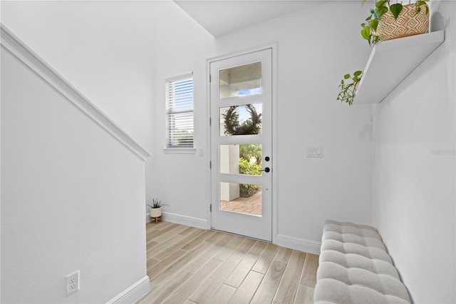 entryway with wood finish floors and baseboards