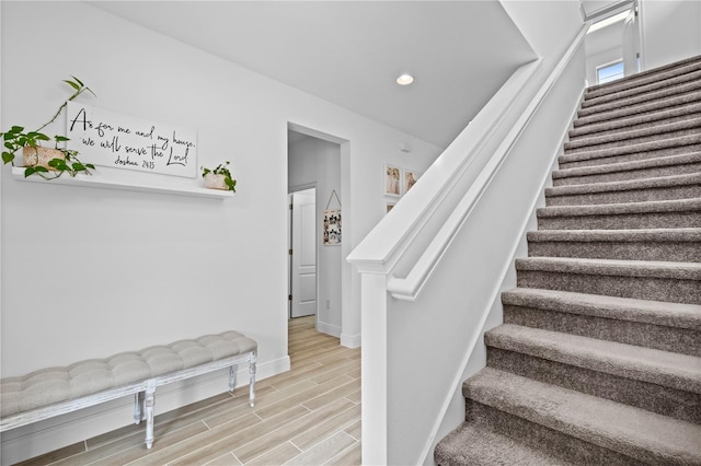 stairway featuring recessed lighting, baseboards, and wood tiled floor