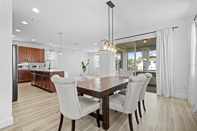 dining area with baseboards, recessed lighting, visible vents, and wood tiled floor