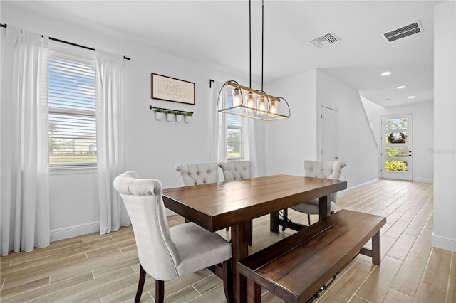 dining space with recessed lighting, baseboards, visible vents, and wood finish floors