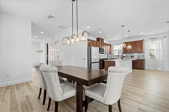 dining space featuring wood finish floors, visible vents, and recessed lighting