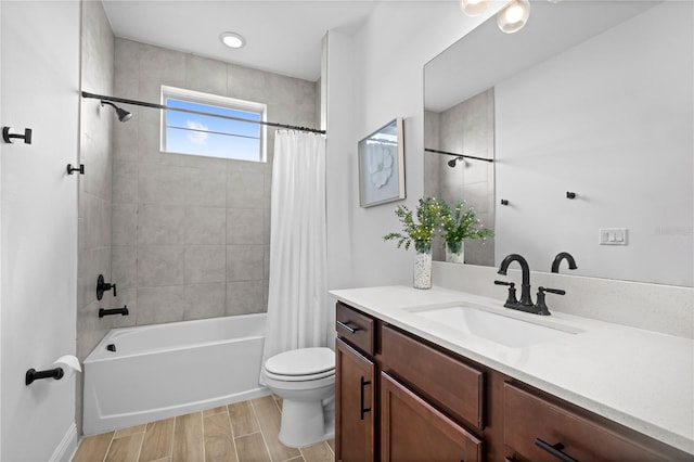 full bath with toilet, vanity, wood finish floors, and shower / bath combo