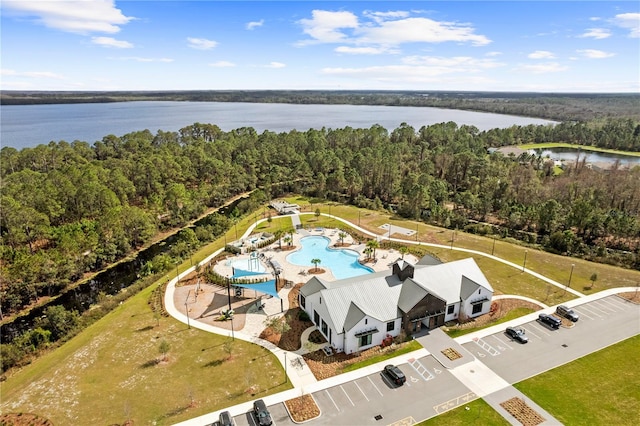 bird's eye view featuring a wooded view and a water view