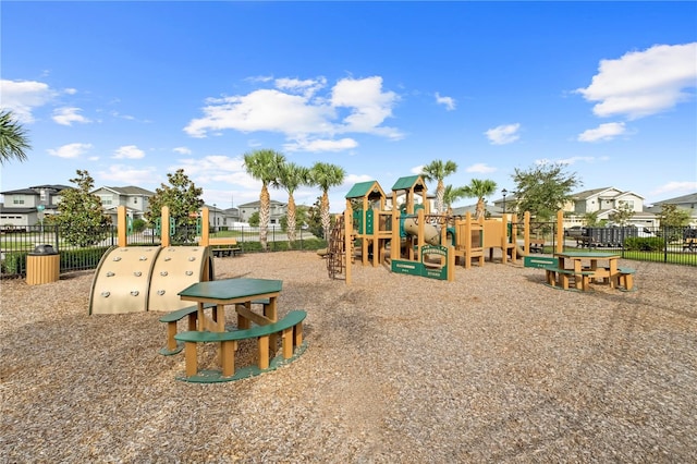 community play area featuring a residential view and fence