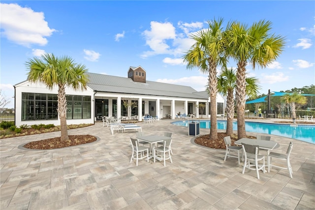 community pool featuring a patio and fence