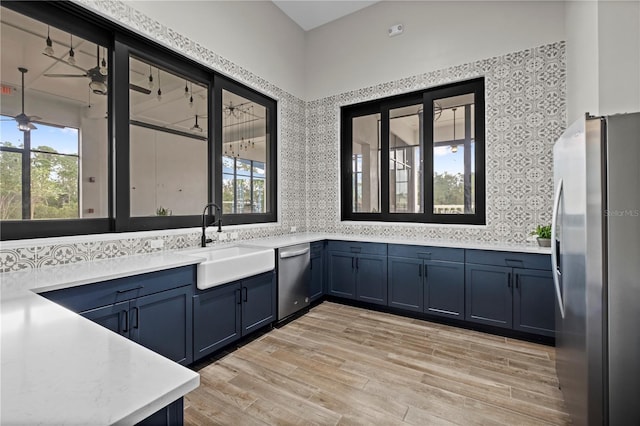 bathroom with vanity, plenty of natural light, wood finished floors, and ceiling fan