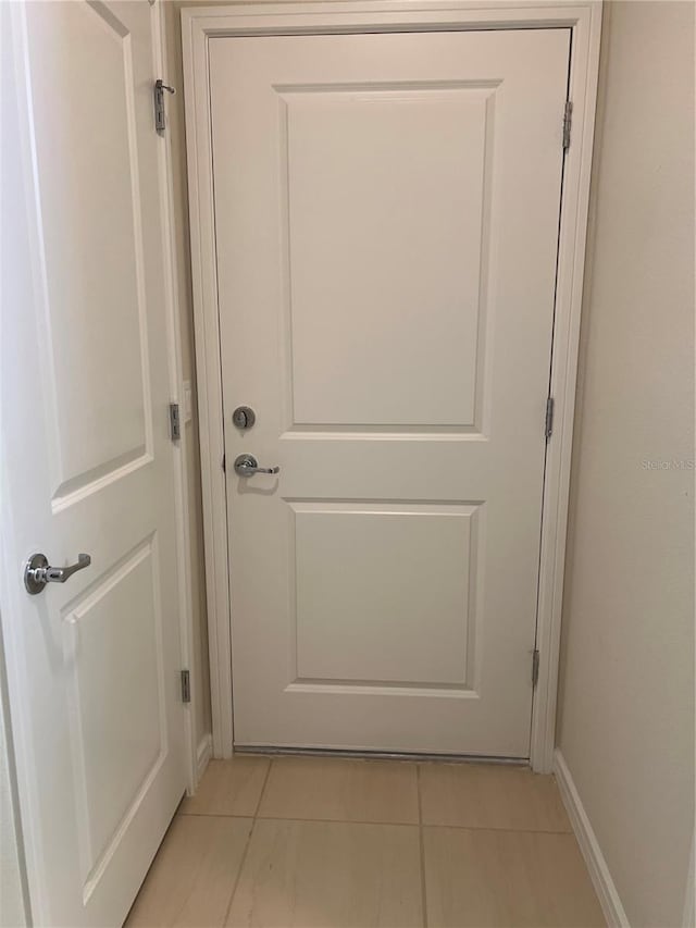 doorway with light tile patterned floors