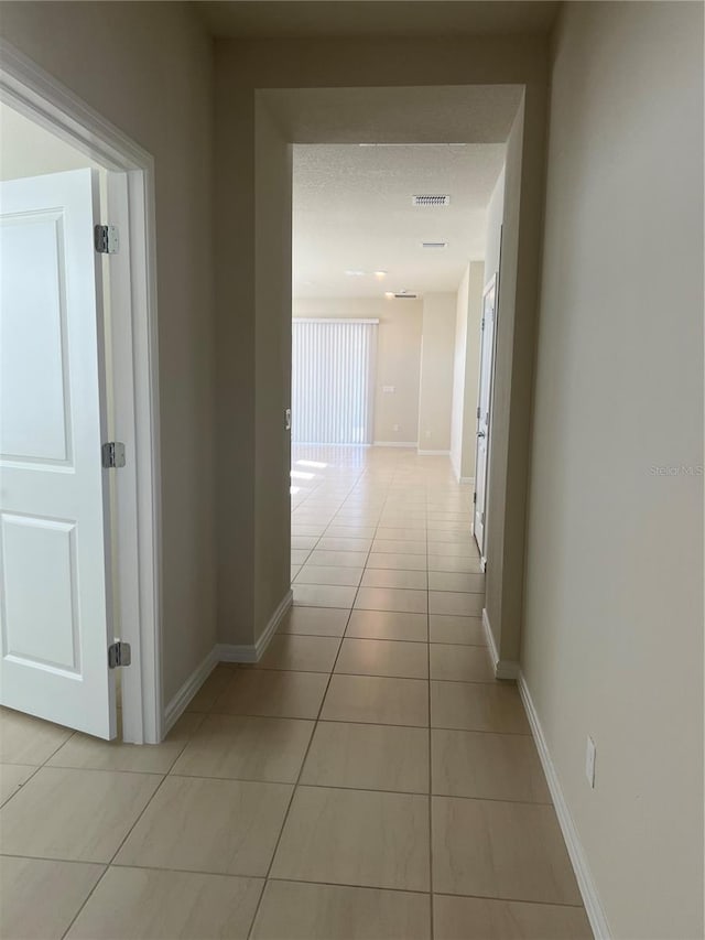 hall with light tile patterned flooring