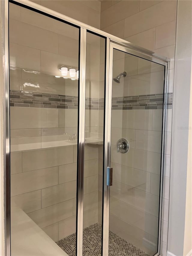 bathroom with a shower with shower door