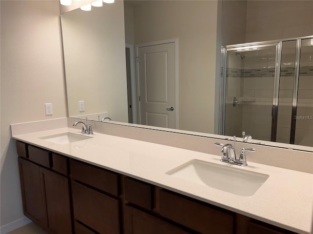 bathroom featuring vanity and a shower with door