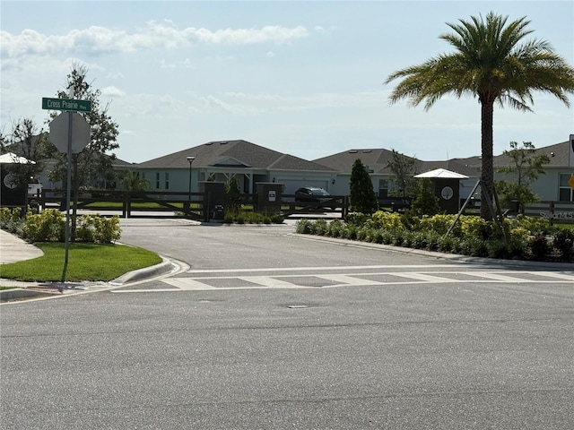 1892 Spring Shower Cir, Kissimmee, FL 34744 - view of asphalt road with traffic signs, curbs, and a residential view