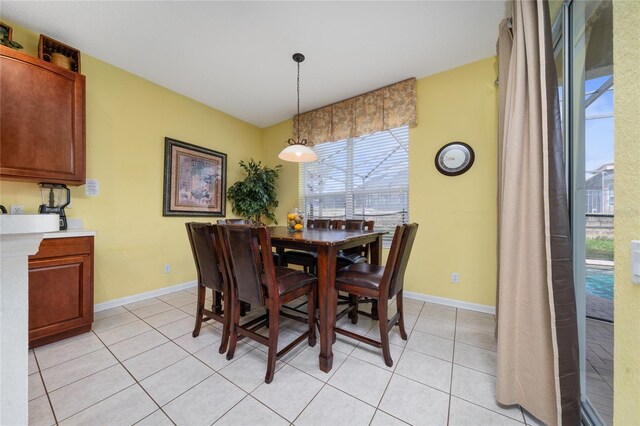 7735 Teascone Blvd, Kissimmee, FL 34747 - dining room featuring healthy amount of natural light, light tile patterned floors, and baseboards