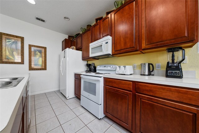 7735 Teascone Blvd, Kissimmee, FL 34747 - kitchen featuring white appliances, light countertops, and light tile patterned floors
