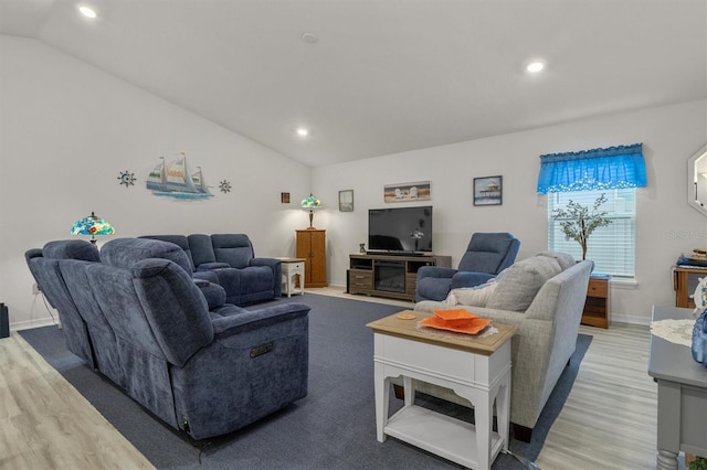 living area featuring light wood-style flooring, vaulted ceiling, and recessed lighting